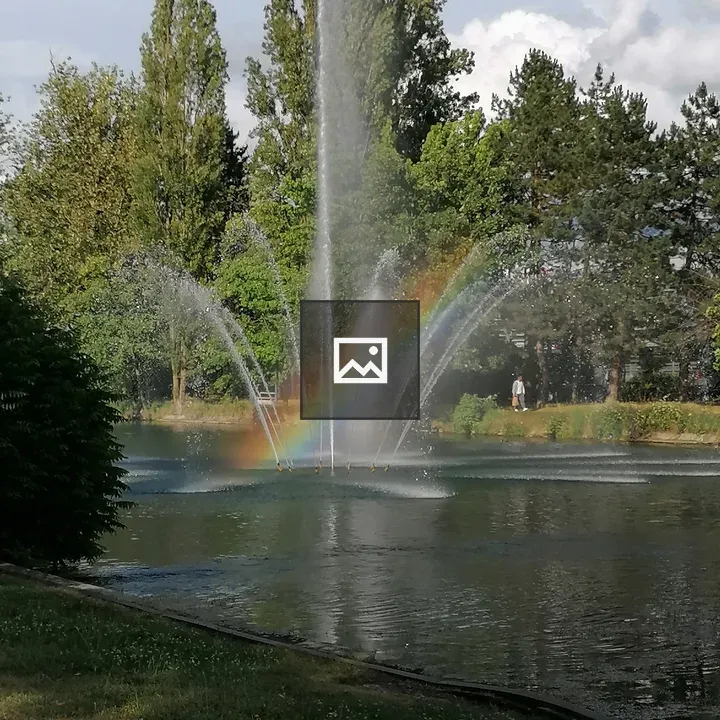 Pond with fountains and rainbow