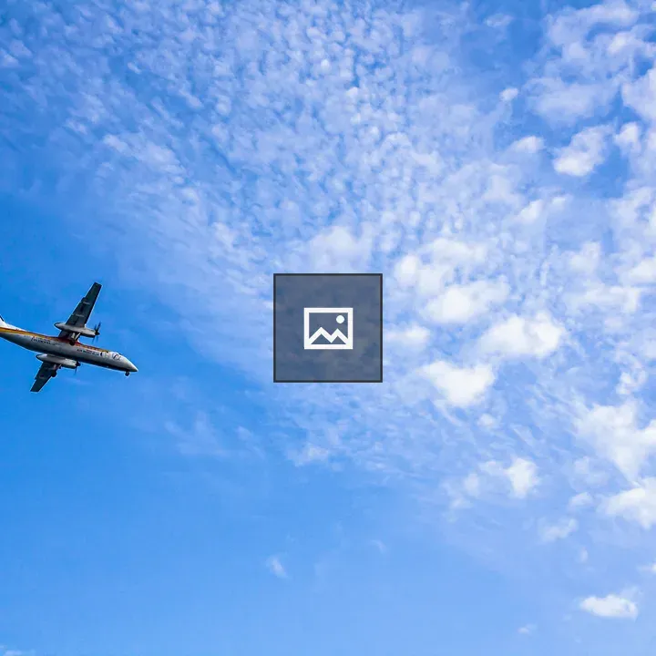 Plane in blue cloudy sky