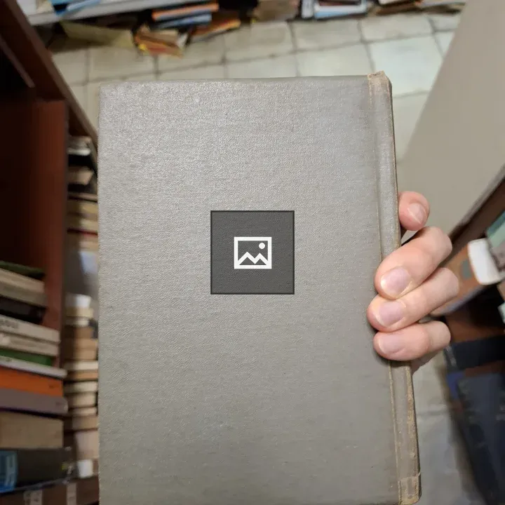 Hand holding back cover of gray hardcover book