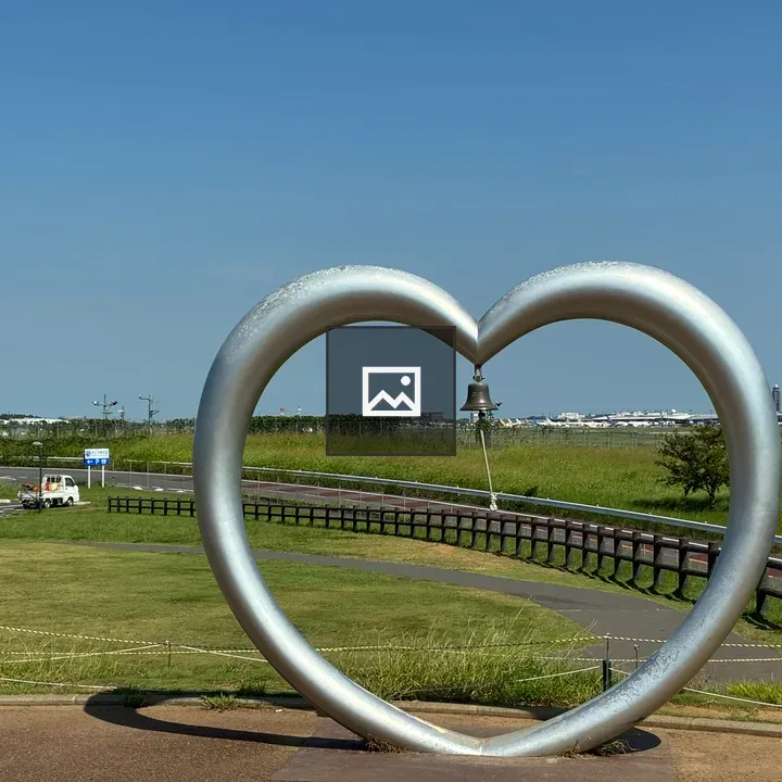 Metallic heart sculpture with bell