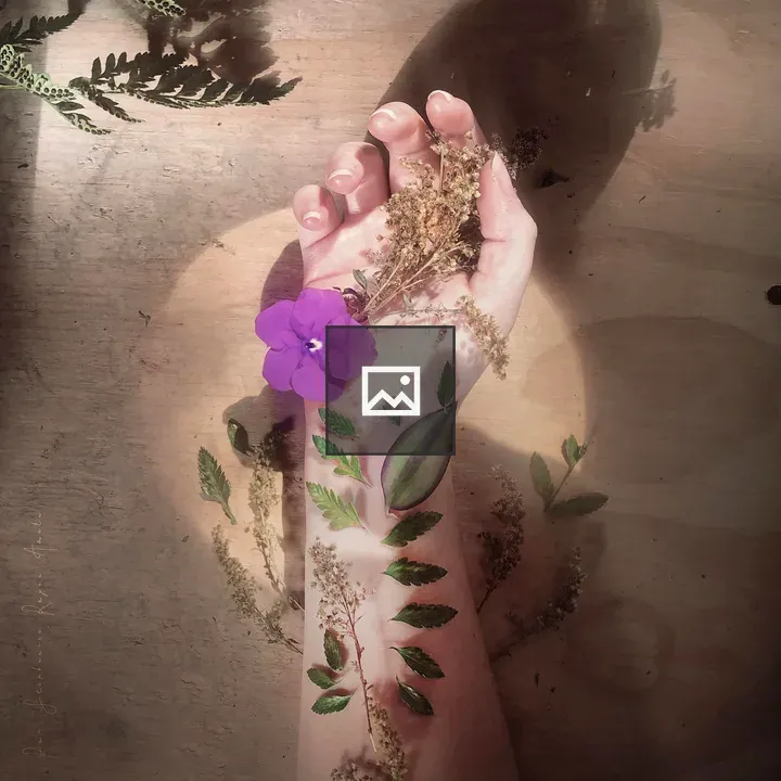 Hand with flowers on table
