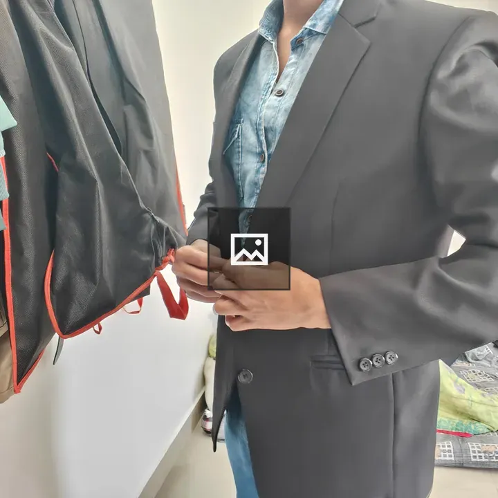 Person Adjusting Black Blazer Buttons