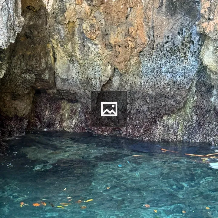 Clear turquoise water at rocky base