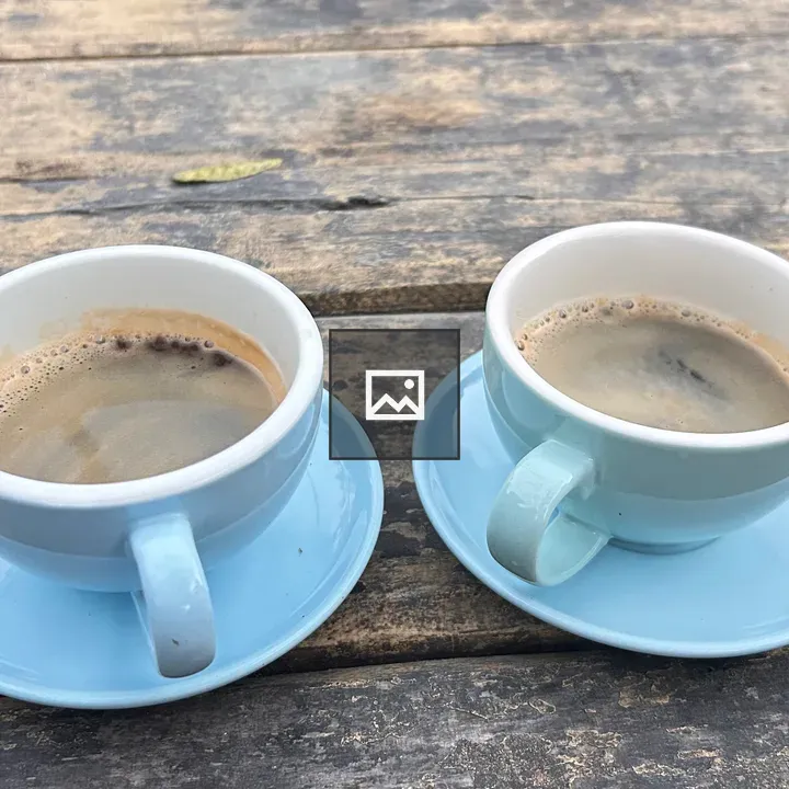 Two blue coffee cups on table