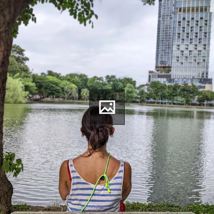 Person on Bench by Lumphini Park