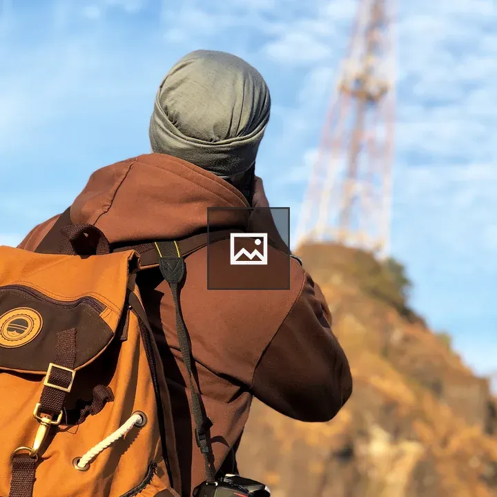 Person with camera looking at tower