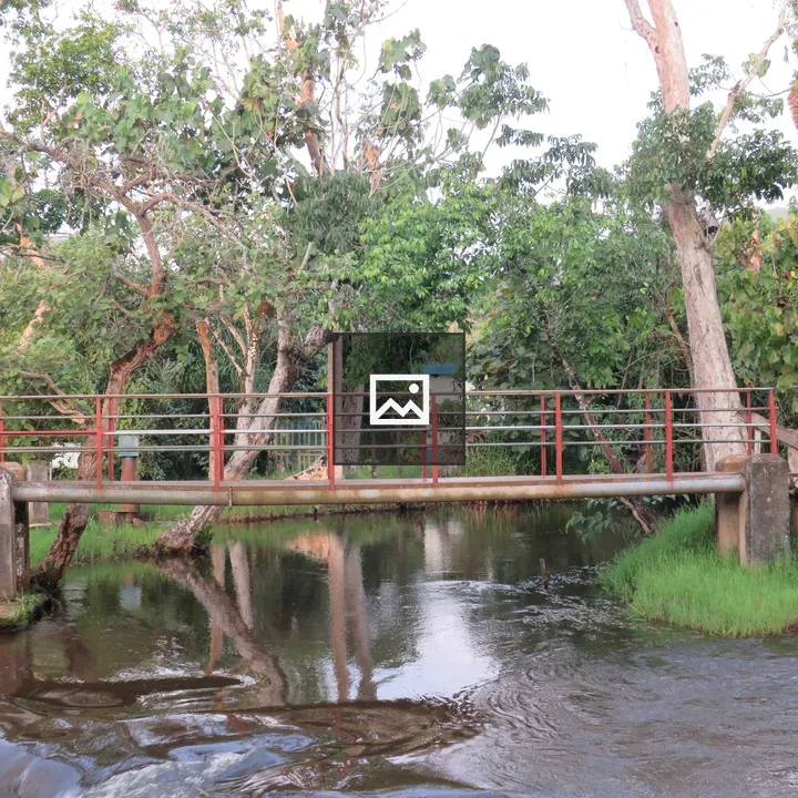 Narrow metal footbridge over Sezibwa River