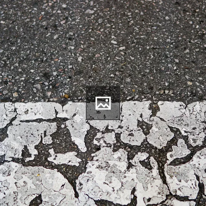 Cracked pedestrian crossing closeup