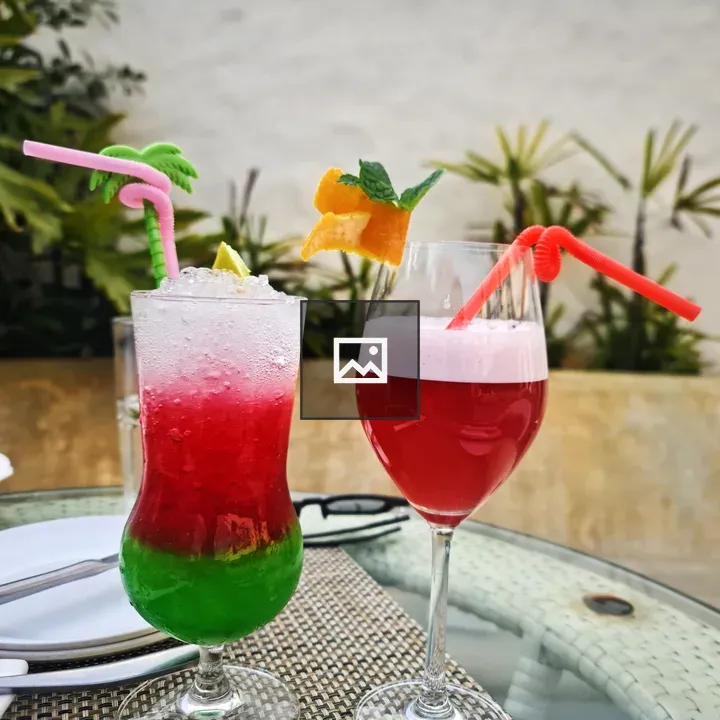 Two colorful cocktails on table