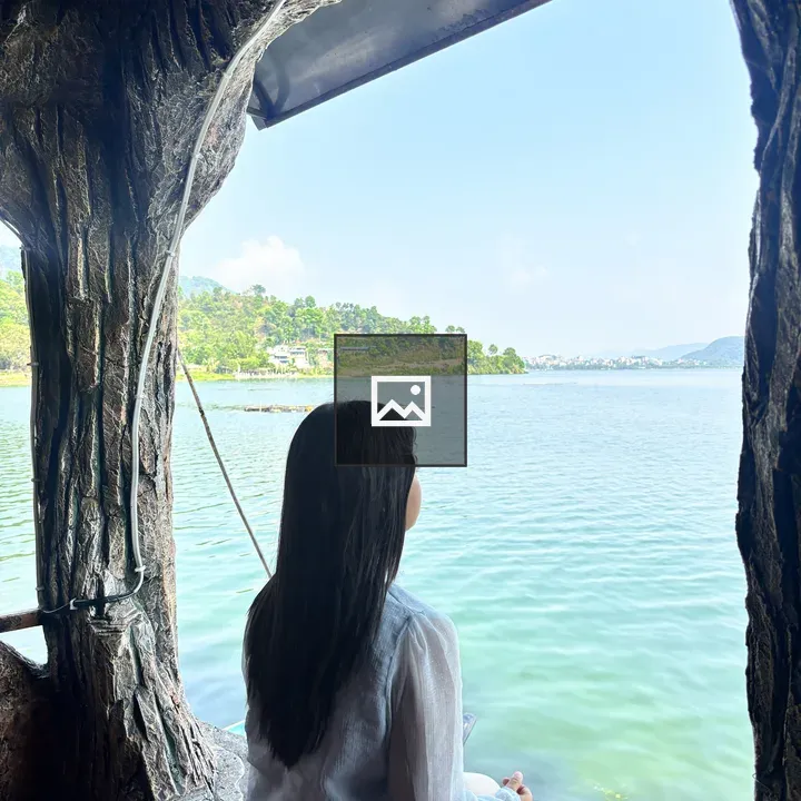 Person in Cave Gazing at Lake