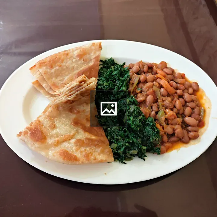 Plate of Kenyan chapati with beans and greens