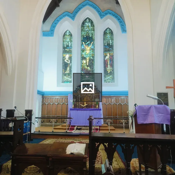 Church interior with purple altar and stained glass