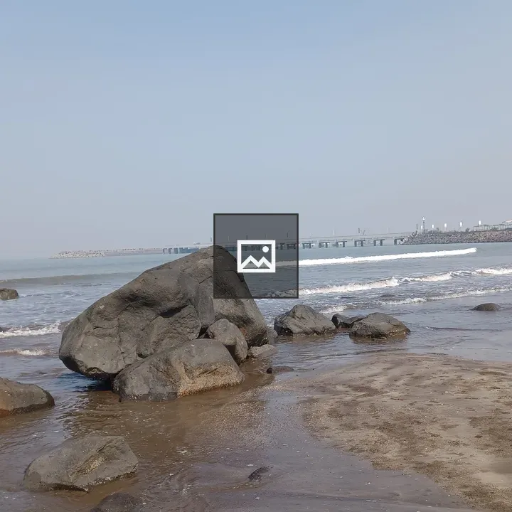 Massive rock on sandy beach