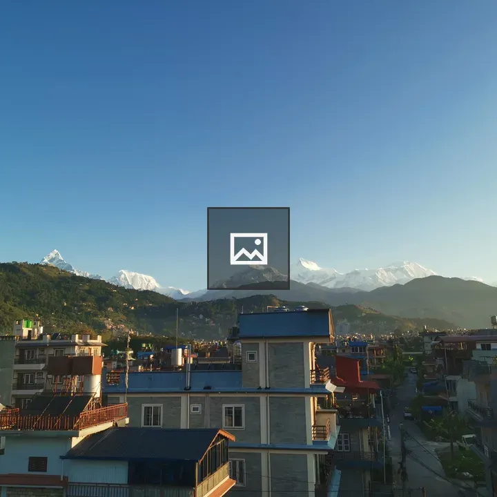 Rooftops Toward Snowy Mountains
