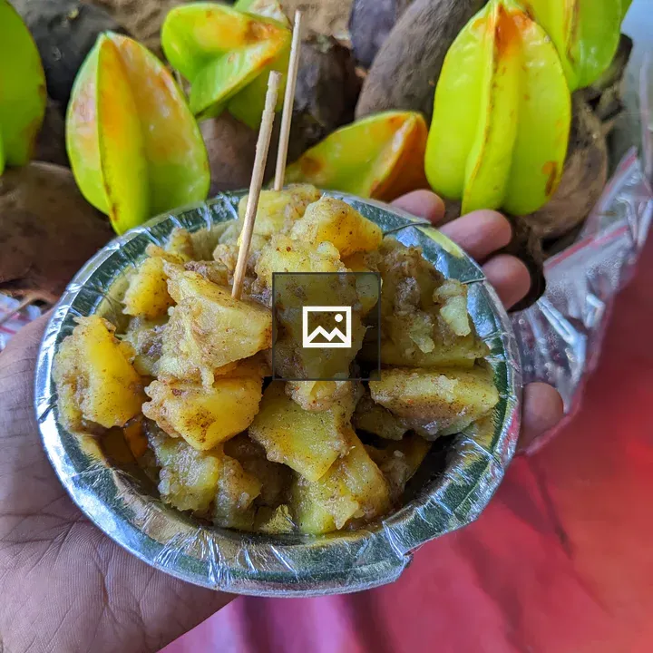 Hand holding Sweet Potato Chaat bowl
