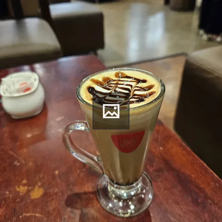 Coffee with latte art on wood table