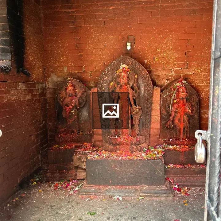 Weathered stone statues with red pigment