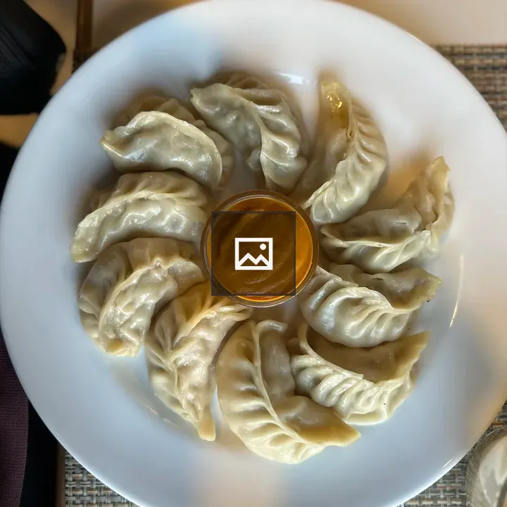Chicken momo on white plate