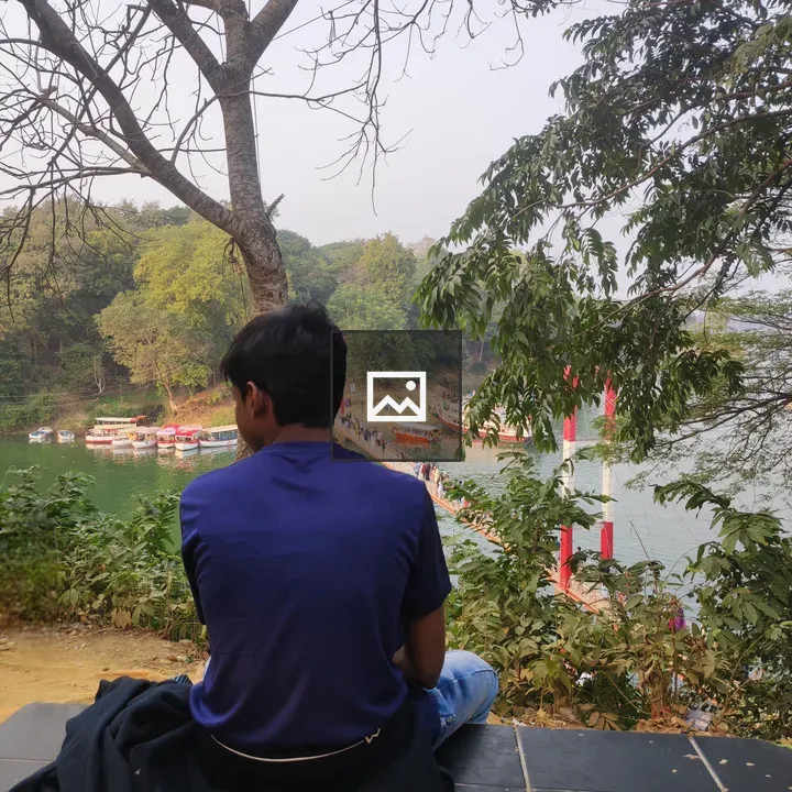 Person on Bench Overlooking River