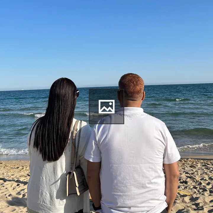 Two people on sandy beach