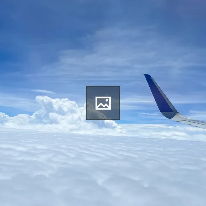 Wing of airplane above clouds