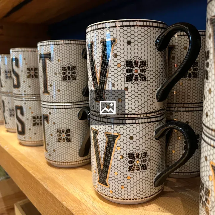 Lettered mugs on table