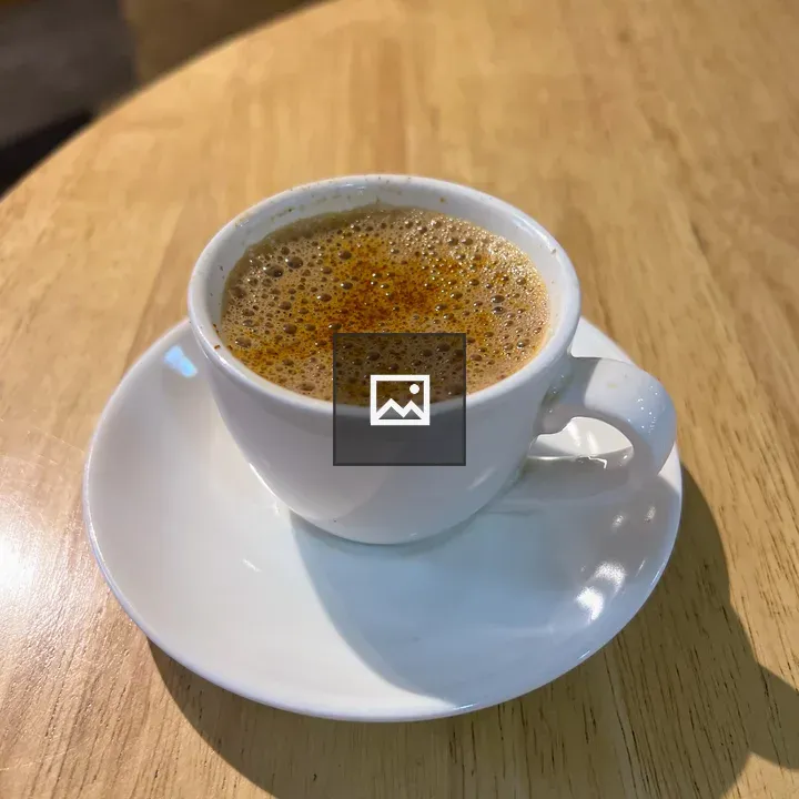 White teacup on wooden table