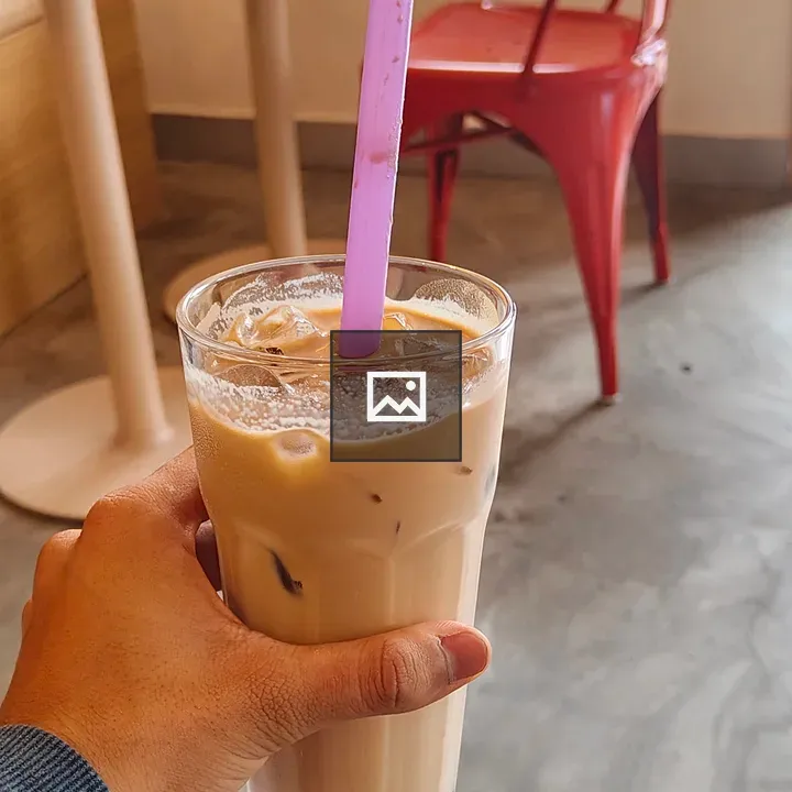 Hand holding iced coffee