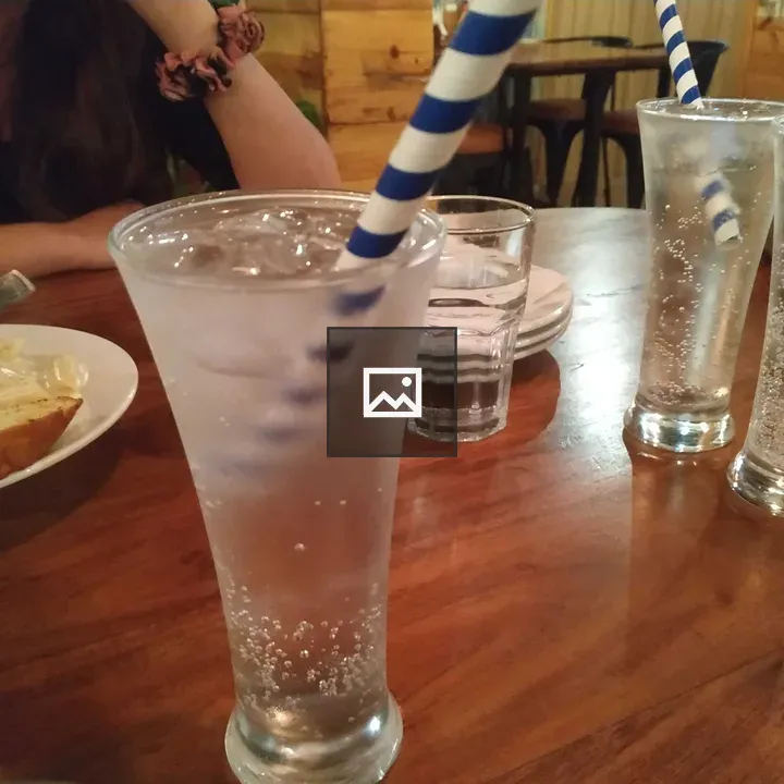 Blue drink with bread and straw