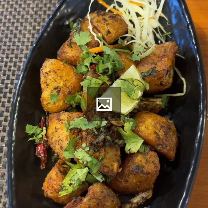 Golden potato wedges on plate