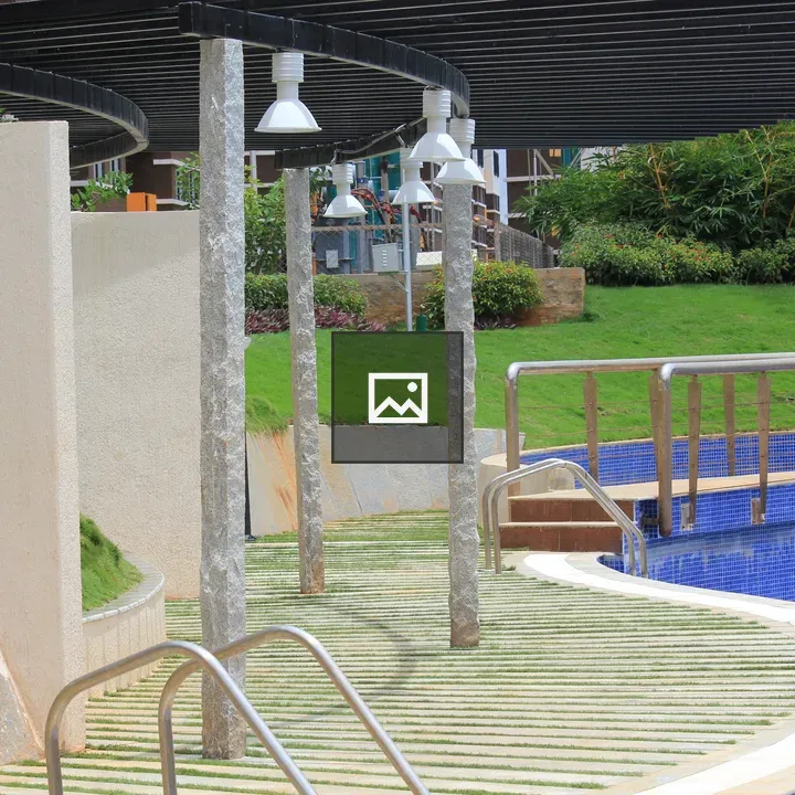 Outdoor pool with curved edge and handrails
