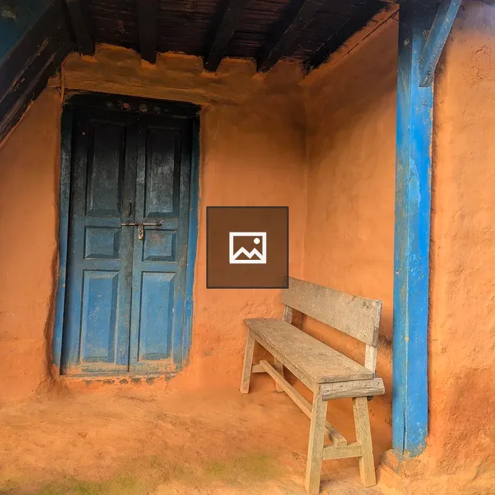 Earthen wall with blue door and bench