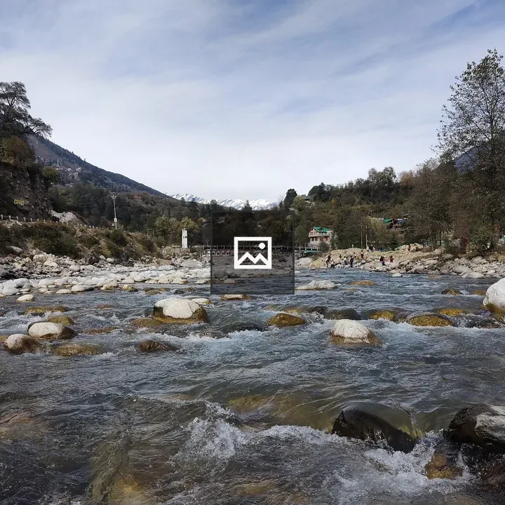 River flowing over rocks with mountains