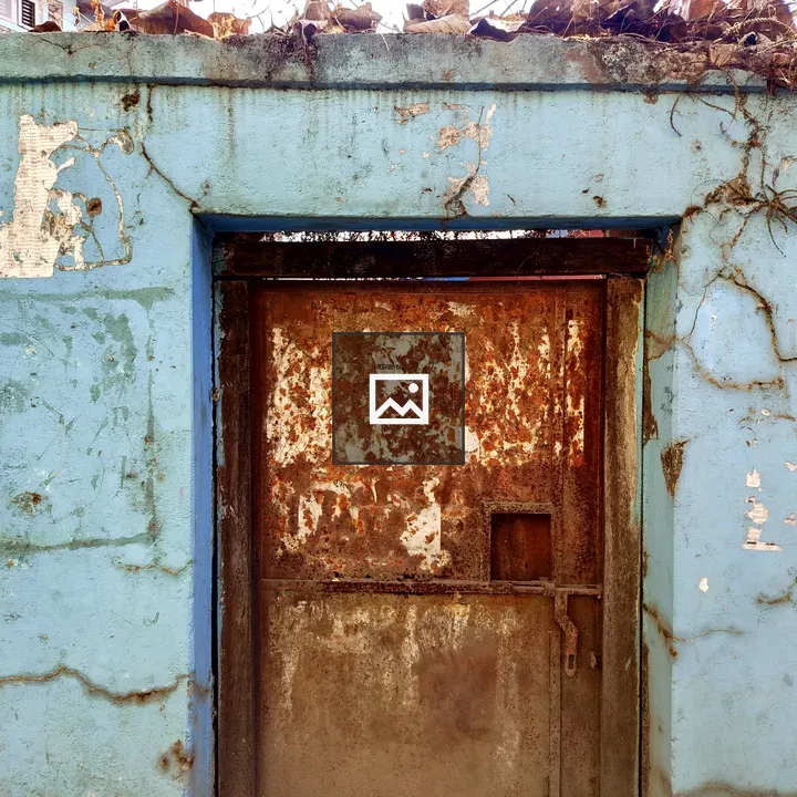 Weathered blue wall with door