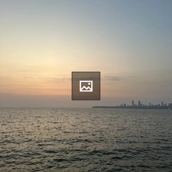Sunset over calm river city skyline