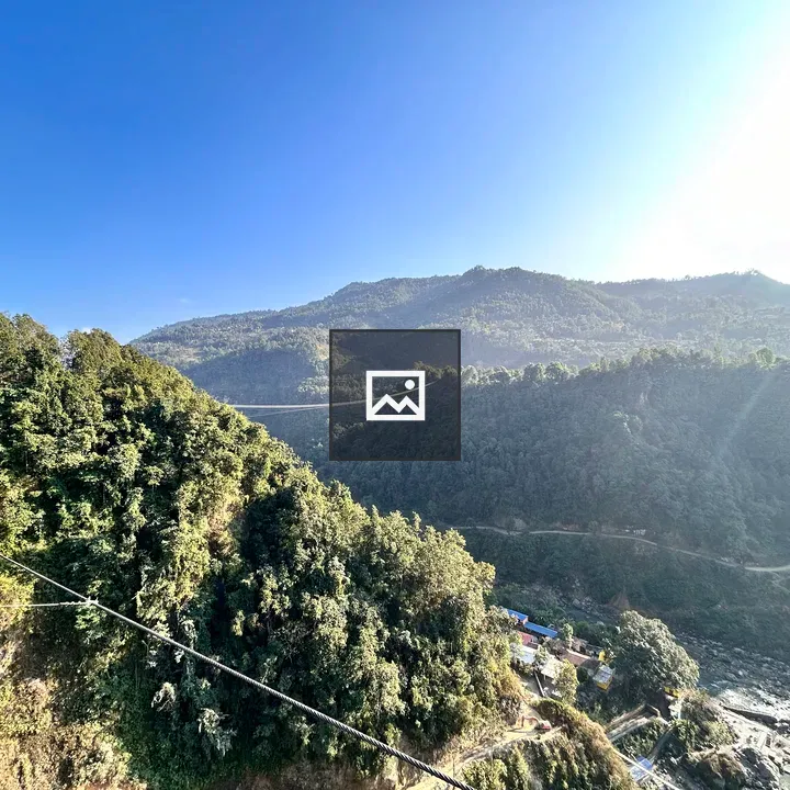 Suspended bridge over green hills
