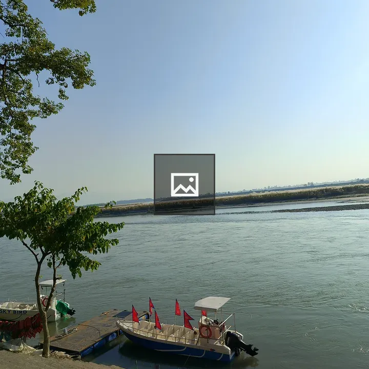 Riverside boats with Nepali flags