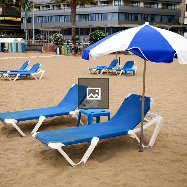 Beach scene with blue lounge chairs