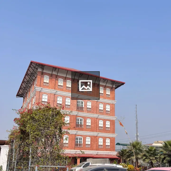 Red brick building with cars