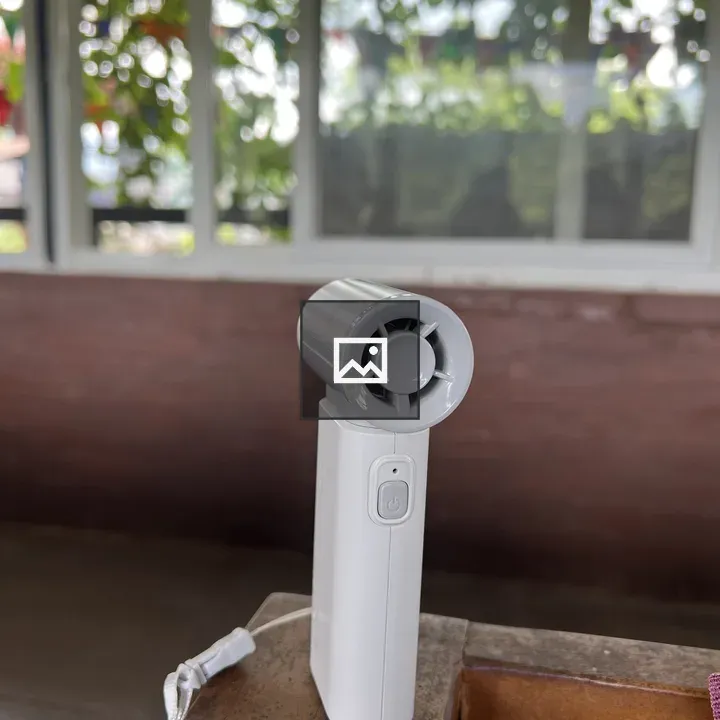 Small white handheld fan