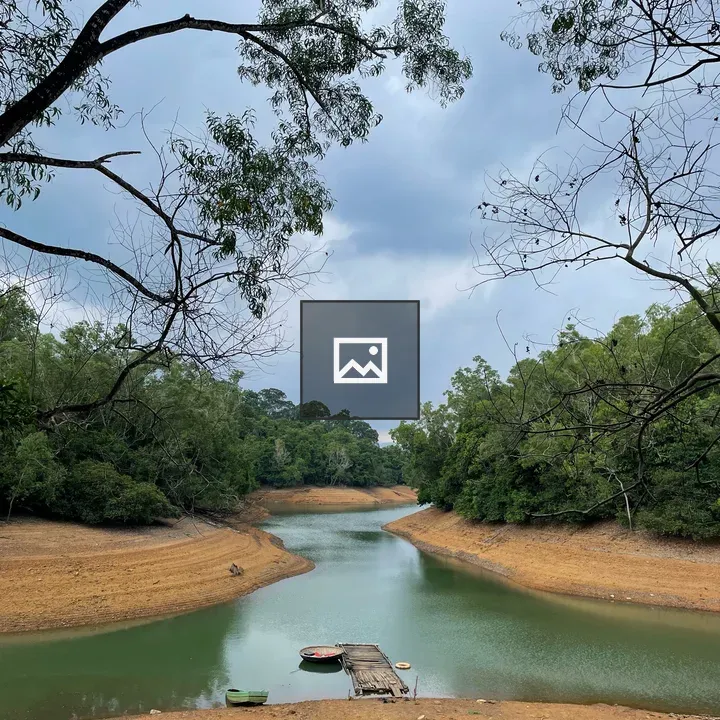 Brown river banks with pier and boat