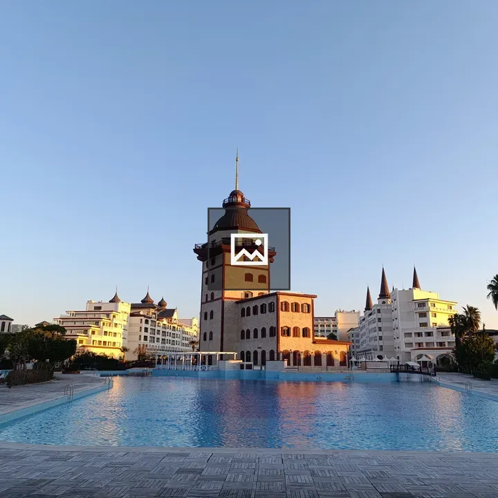 Elegant building beside pool with towers