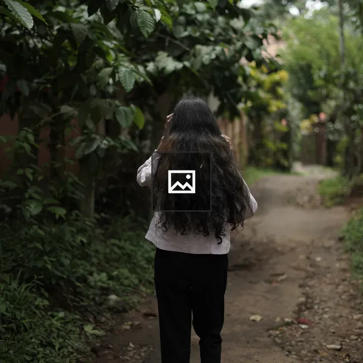 Woman Walking Through Forest