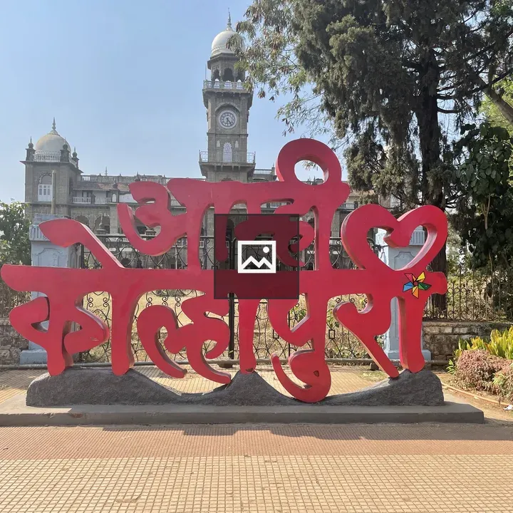 Red sculpture and historic building