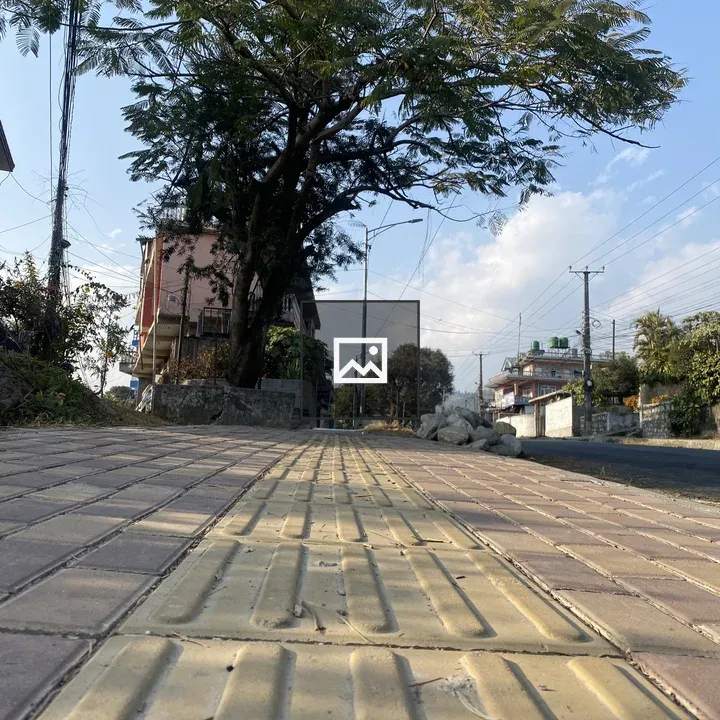 Textured sidewalk with yellow tactile strip