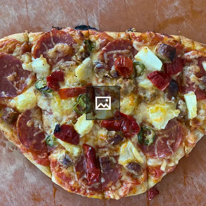 Hand-tossed pizza on board