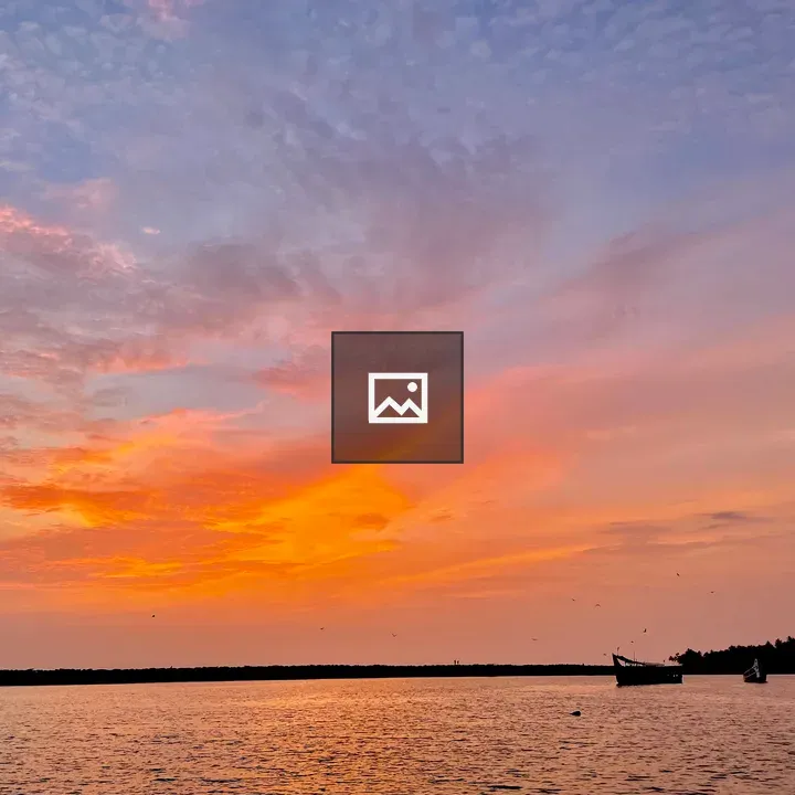 Sunset over boats at Puthiyappa Harbour