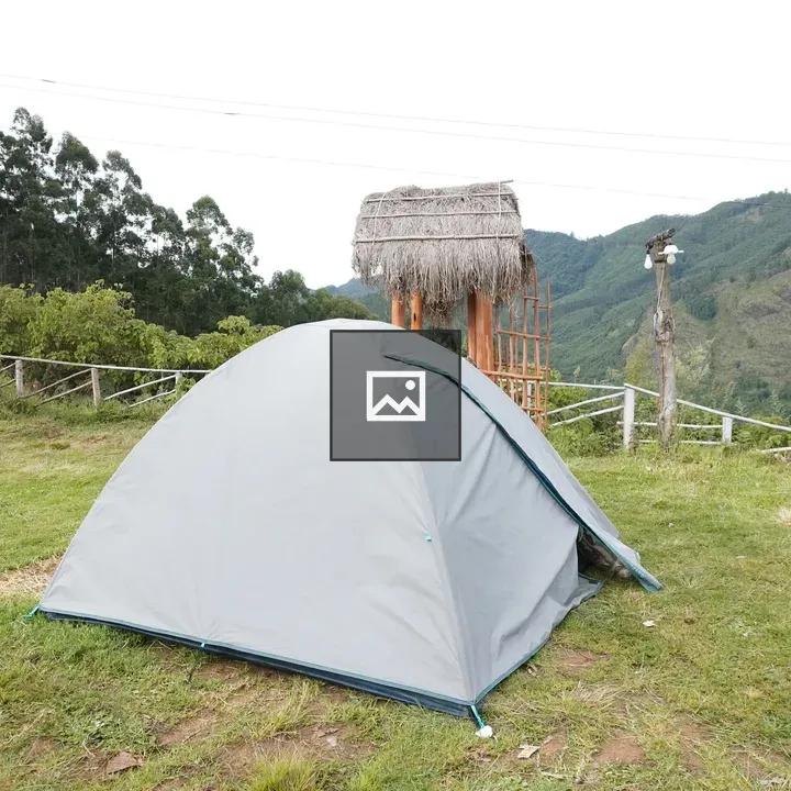 Gray camping tent in grassy area