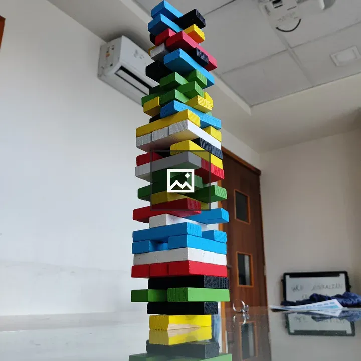 Tower of wooden blocks on glass table