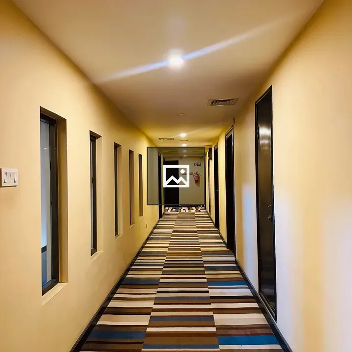 Long hallway with striped carpet